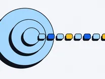 Three nested circles with a row of small colored blocks flowing out of the smallest.